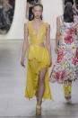 <p><i>Model wears a yellow sparkling dress with cutouts from the SS18 Prabal Gurung collection. (Photo: ImaxTree) </i></p>