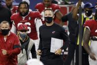 Arizona Cardinals head coach Kliff Kingsbury, center in black, jogs onto the field after their 38-10 win against the Dallas Cowboys in an NFL football game in Arlington, Texas, Monday, Oct. 19, 2020. (AP Photo/Ron Jenkins)