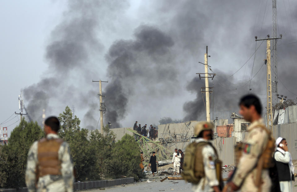ADDS DATE - Smoke rises as Kabul residents set fire to part of the Green Village compound that has been attacked frequently, a day after a Taliban suicide attack in Kabul, Tuesday, Sept. 3, 2019. An interior ministry spokesman said some hundreds of foreigners were rescued after the attack targeted the compound, which houses several international organizations and guesthouses. (AP Photo/Rahmat Gul)