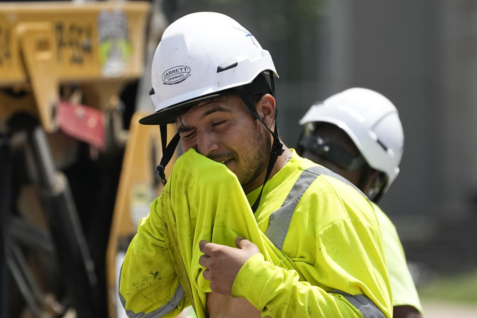 Construction worker Fernando Padilla wipes his face as he works in the heat, Friday, June 30, 2023 in Nashville, Tenn. The entire planet sweltered for the two unofficial hottest days in human recordkeeping Monday and Tuesday, according to University of Maine scientists at the Climate Reanalyzer project. The unofficial heat records come after months of unusually hot conditions due to climate change and a strong El Nino event. (AP Photo/George Walker IV)