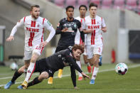 Cologne's Jannes Horn, left, and Bremen's Joshua Sargent, front right, challenge for the ball during the German Bundesliga soccer match between 1. FC Cologne and Werder Bremen in Cologne, Germany, Sunday, March 7, 2021. (Rolf Vennenbernd/dpa via AP)