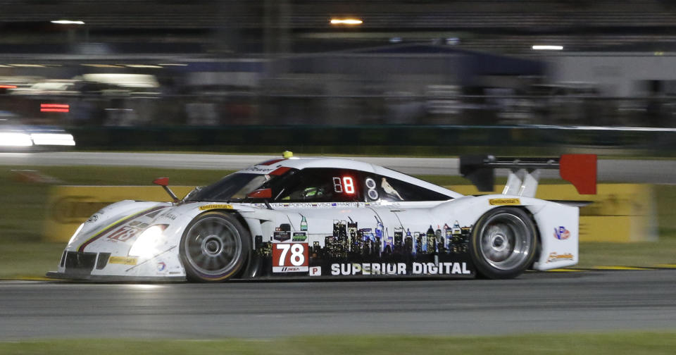 E.J. Viso, of Venezuela, drives the Starworks Riley DP during the IMSA Series Rolex 24 hour auto race at Daytona International Speedway in Daytona Beach, Fla., Saturday, Jan. 25, 2014.(AP Photo/John Raoux)