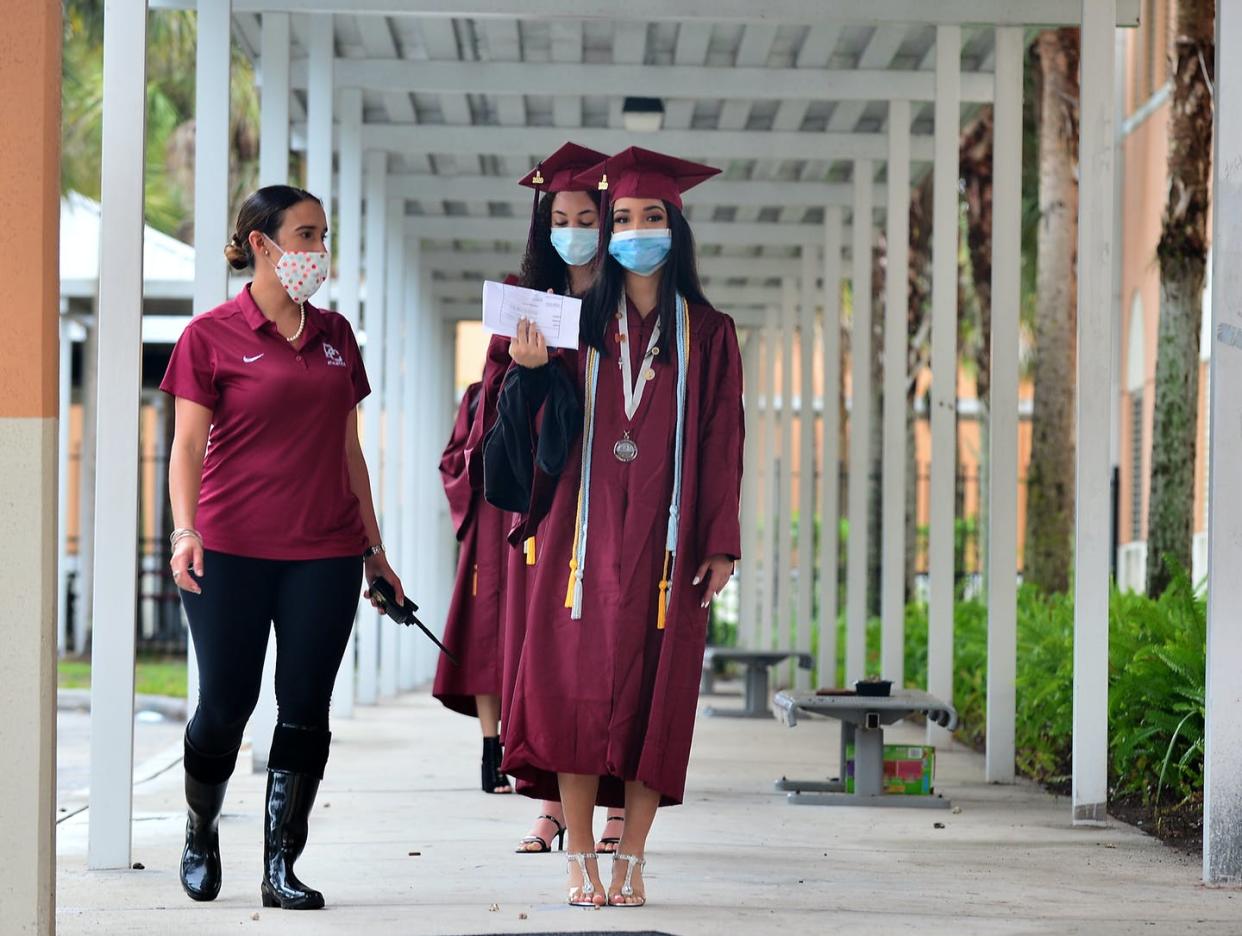 <span class="caption">College entrance exams are being rethought.</span> <span class="attribution"><a class="link " href="https://www.gettyimages.com/detail/news-photo/melissa-fernandez-directs-students-wearing-protective-masks-news-photo/1213157483?adppopup=true" rel="nofollow noopener" target="_blank" data-ylk="slk:Johnny Louis/Getty Images;elm:context_link;itc:0;sec:content-canvas">Johnny Louis/Getty Images</a></span>