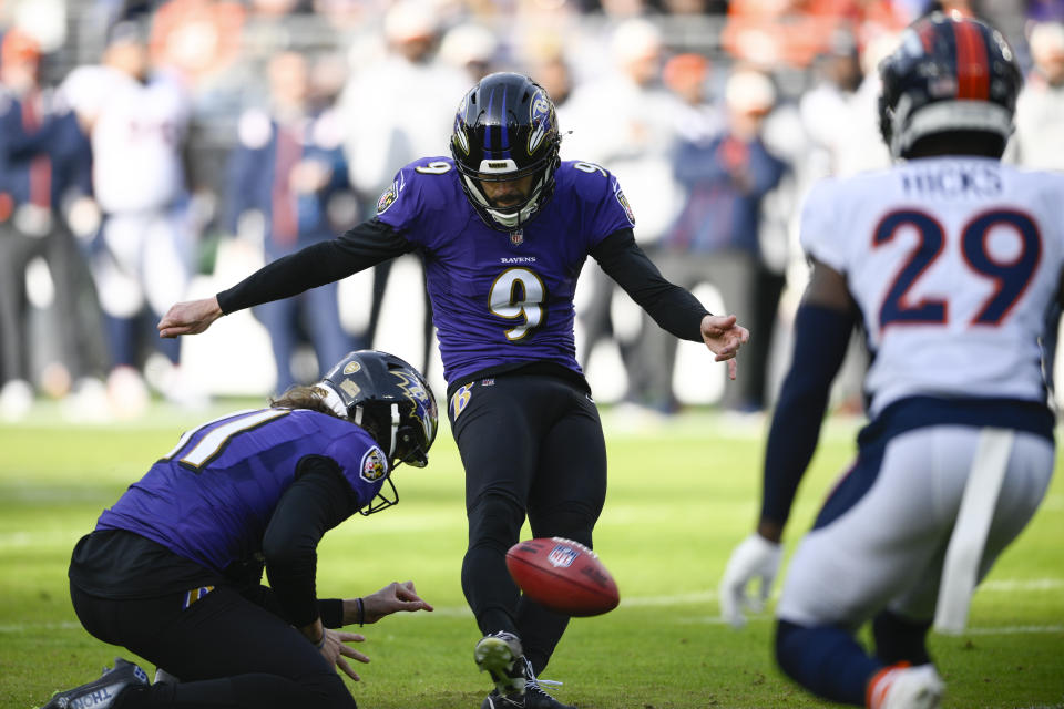 Baltimore Ravens place kicker Justin Tucker (9) kicks a field goal, held by Baltimore Ravens punter Jordan Stout (11), in the first half of an NFL football game against the Denver Broncos, Sunday, Dec. 4, 2022, in Baltimore. (AP Photo/Nick Wass)