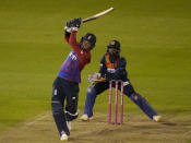 England's Sam Curran, hits 6 runs off the bowling of Sri Lanka's Wanindu Hasaranga, to win the second T20 international cricket match between England and Sri Lanka in Cardiff, Wales, Thursday, June 24, 2021. (AP Photo/Alastair Grant)