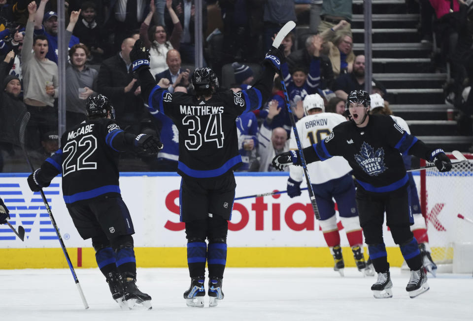 Toronto Maple Leafs forward Auston Matthews (34) celebrates his goal against the Florida Panthers with teammates Jake McCabe (22) Calle Jarnkrok (19) during the third period of an NHL hockey game in Toronto on Wednesday, March 29, 2023. (Nathan Denette/The Canadian Press via AP)