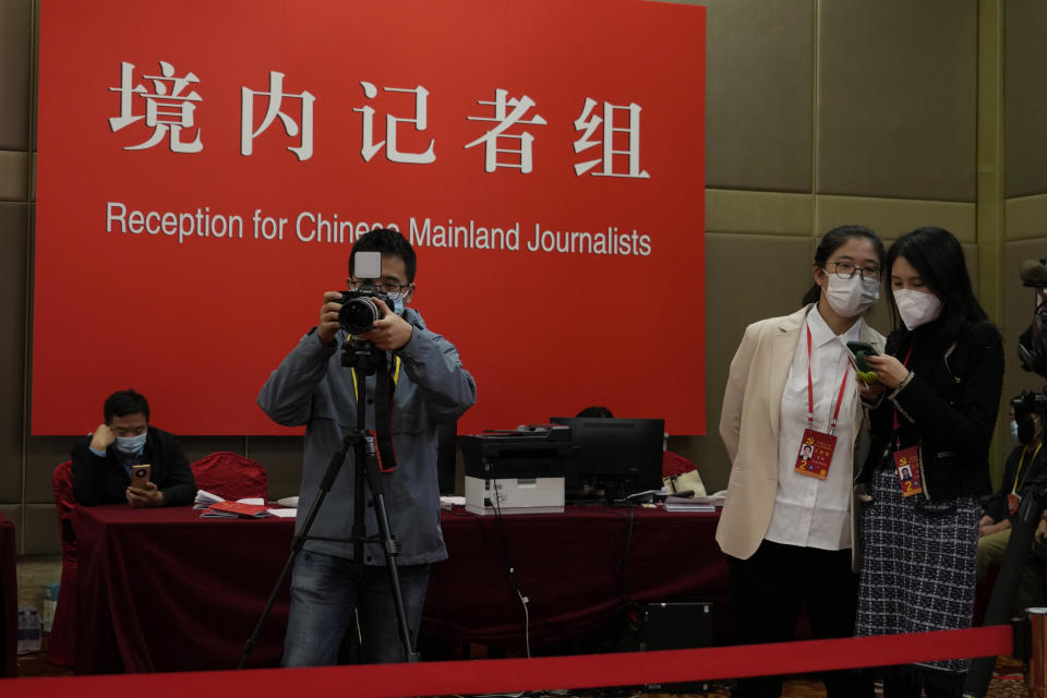Chinese journalists work near an area with a sign for Chinese Mainland Journalists a press conference held on the sidelines of the 20th Party Congress in Beijing on Oct. 20, 2022. China's ruling Communist Party has long relied on a critically important and secretive internal reference system to learn about issues considered too sensitive for the public to know. But as Chinese leader Xi Jinping tightens censorship and consolidates his rule, Chinese academics and journalists say even this internal system is struggling to give frank assessments. (AP Photo/Ng Han Guan)