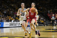 Georgia guard Alisha Lewis (23) drives to the basket past Iowa guard Caitlin Clark (22) in the first half of a second-round college basketball game in the NCAA Tournament, Sunday, March 19, 2023, in Iowa City, Iowa. (AP Photo/Charlie Neibergall)