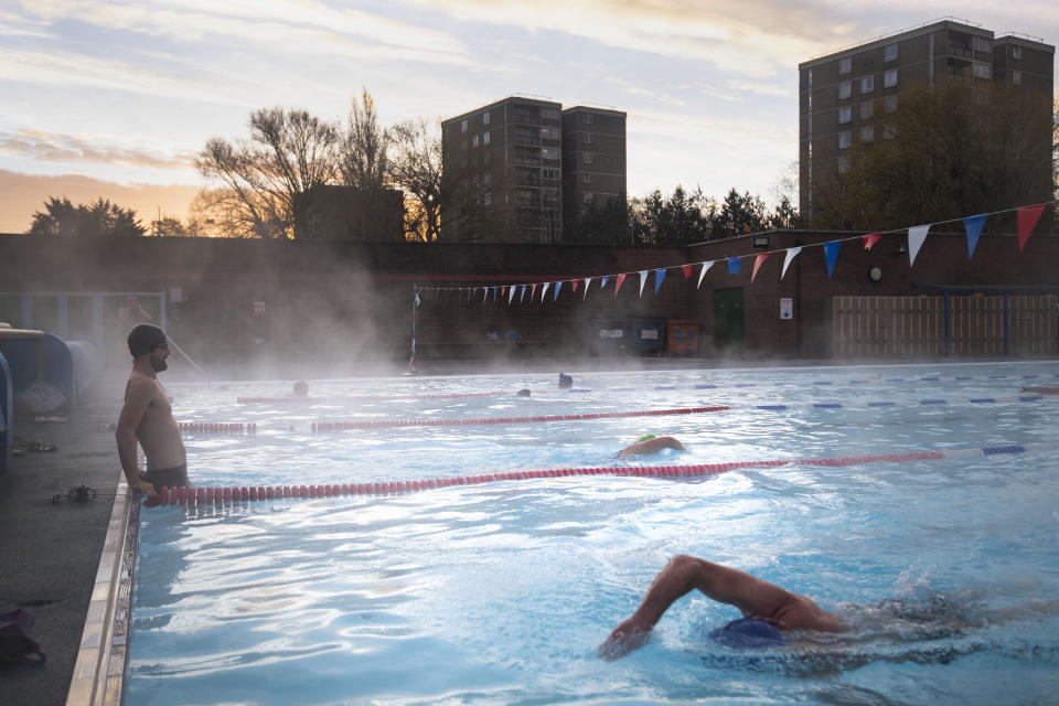 Early morning swimmers during sunrise at Charlton Lido in Hornfair Park, London, on its first day of reopening after the second national lockdown ended and England enters a strengthened tiered system of regional coronavirus restrictions.