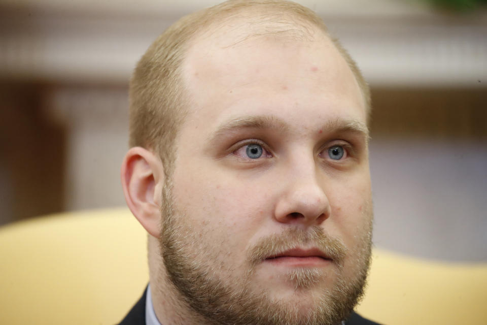 FILE - Joshua Holt sits with President Donald Trump in the Oval Office of the White House, May 26, 2018, in Washington. On Thursday, Feb. 22, 2024, Holt, a Utah man imprisoned for nearly two years in Venezuela, sued Venezuelan President Nicolás Maduro, accusing the leftist leader of heading a “criminal enterprise” that kidnaps, tortures and unjustly imprisons American citizens. (AP Photo/Alex Brandon, File)