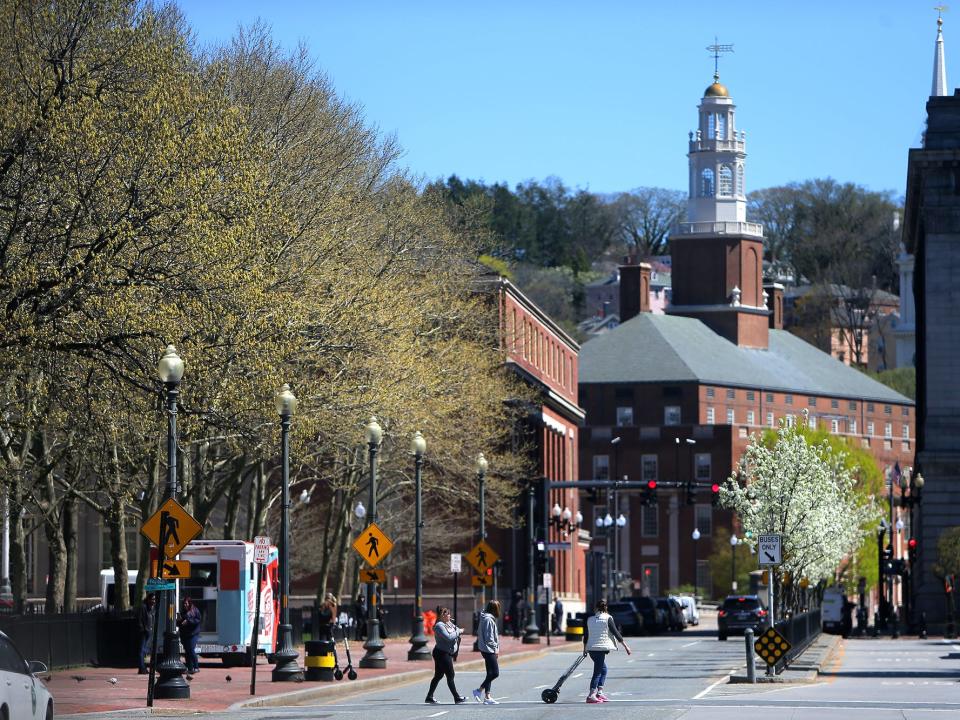 Pedestrians cross Washington Street to Kennedy Plaza in Providence, RI on April 25, 2019.