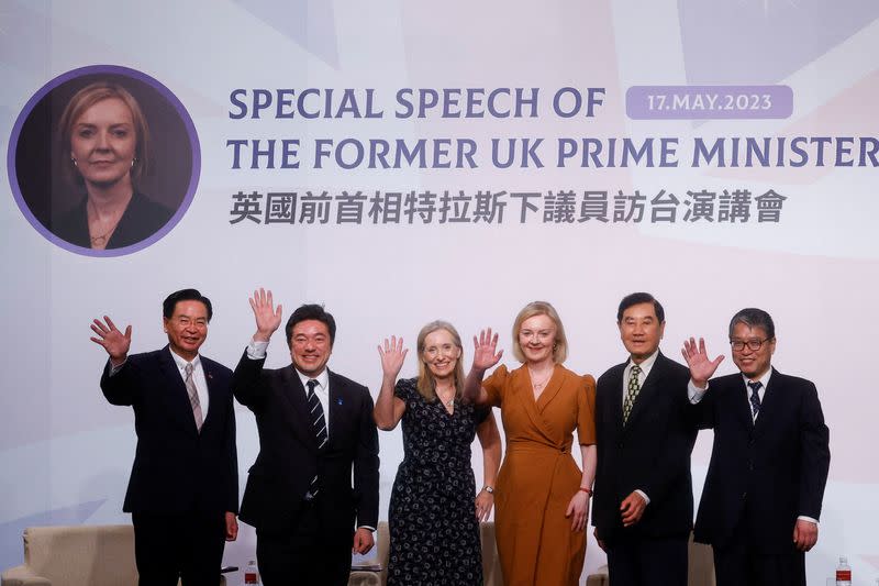 Former British Prime Minister Liz Truss poses for a group photo during an event in Taipei