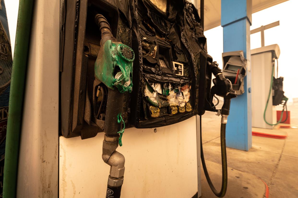 A gas station pump displays a melted handle on Aug. 6, 2021, in Greenville, Calif. The Dixie Fire burned through the community two days prior, destroying most of the town.