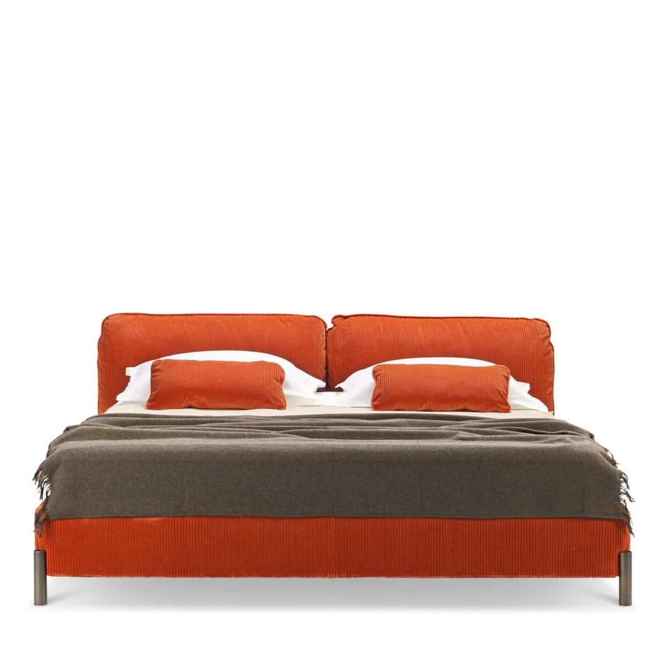 wide orange bed with brown throw