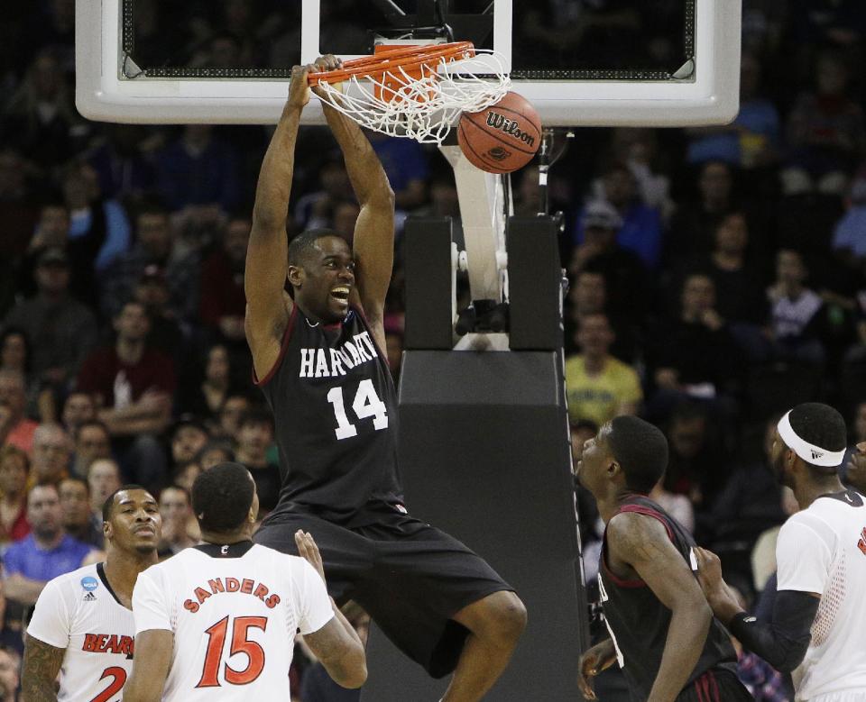 Harvard’s Steve Moundou-Missi (14) dunks against Cincinnati in the second half during the second-round of the NCAA men's college basketball tournament in Spokane, Wash., Thursday, March 20, 2014. (AP Photo/Young Kwak)