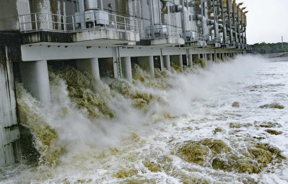 This photo shows the Gulf Intracoastal Waterway West Closure Complex, Saturday, July 13, 2019 in Belle Chasse, La. It is the largest pumping station in the world and as is part of the Southeast Louisiana Flood Protection Authority-West and the West Jefferson (Parish) and Algiers Levee District serving the residents of West Bank of the Greater New Orleans. The 11 pumps are being started because of anticipated rain from Hurricane Barry. The 11 pumps at full capacity pump 8.6 million gallons per minute, which would fill up the Superdome in 110 minutes and would fill an Olympic-size swimming in 3.5 seconds. (AP Photo/Matthew Hinton)