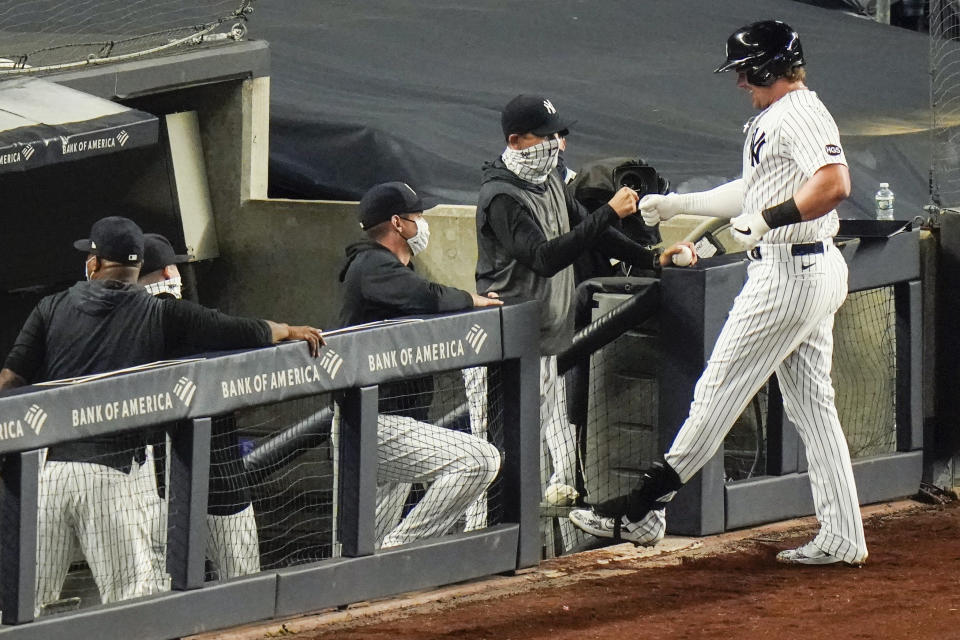 New York Yankees' Luke Voit, right, celebrates with teammates after hitting a three-run home run during the sixth inning of a baseball game against the Toronto Blue Jays Wednesday, Sept. 16, 2020, in New York. (AP Photo/Frank Franklin II)