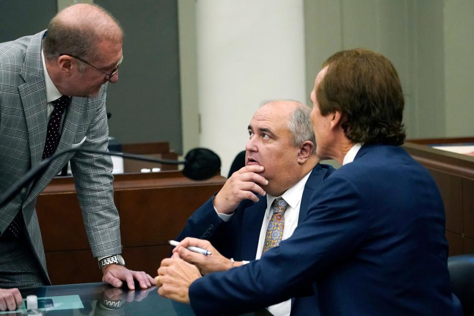 John Davis, former director of the Mississippi Department of Human Services, confers with defense attorneys Merrida Coxwell, right, and Charles Mullins, left, in Jackson, Miss., on Sept. 22, 2022. Davis pleaded guilty to state and federal charges in a conspiracy to misspend tens of millions of dollars that were intended to help needy families in one of the poorest states in the U.S. as part of the largest public corruption case in Mississippi history.