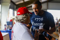 FILE - Georgia gubernatorial candidate Vernon Jones speaks to an attendee of the 17th annual Floyd County GOP Rally at the Coosa Valley Fairgrounds on Saturday, Aug. 7, 2021 in Rome, Ga. The rewards of an early Donald Trump endorsement will be on display Saturday, Sept. 25 in Georgia. A three-man ticket of candidates he’s backing in 2022 Republican primaries for statewide office will take the stage with him. (Troy Stolt/Chattanooga Times Free Press via AP)