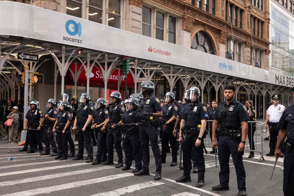 Police officers line up to control the crowd (AFP via Getty Images)