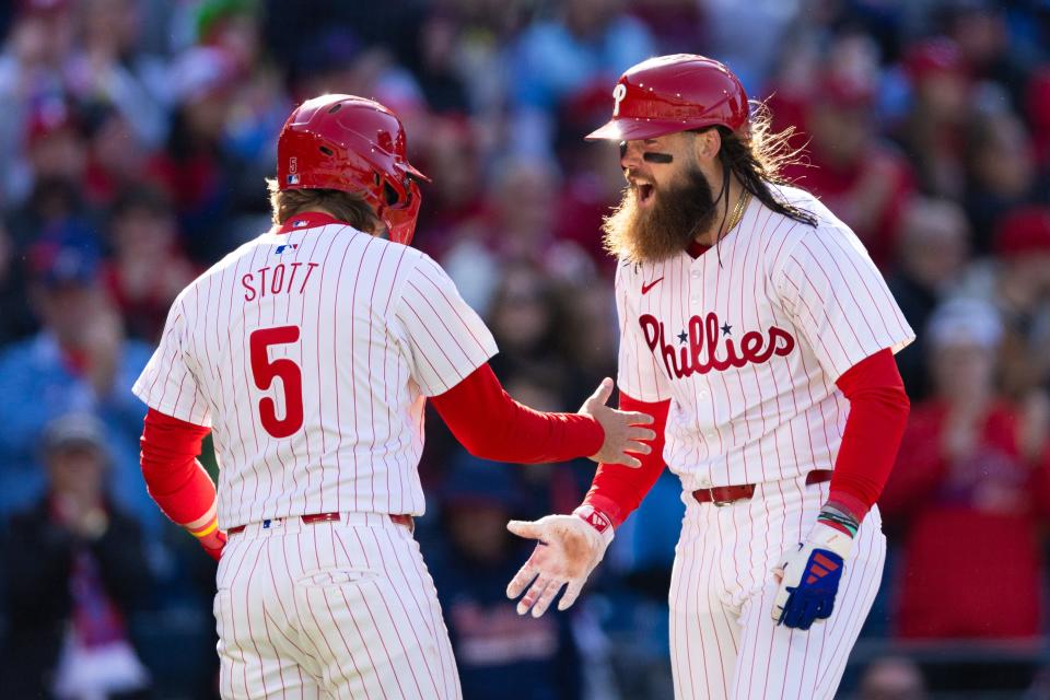 Philadelphia Phillies left-fielder Brandon Marsh (16) celebrates with second baseman Bryson Stott (5) after hitting a two-run homer during the fifth inning against the Atlanta Braves at Citizens Bank Park.