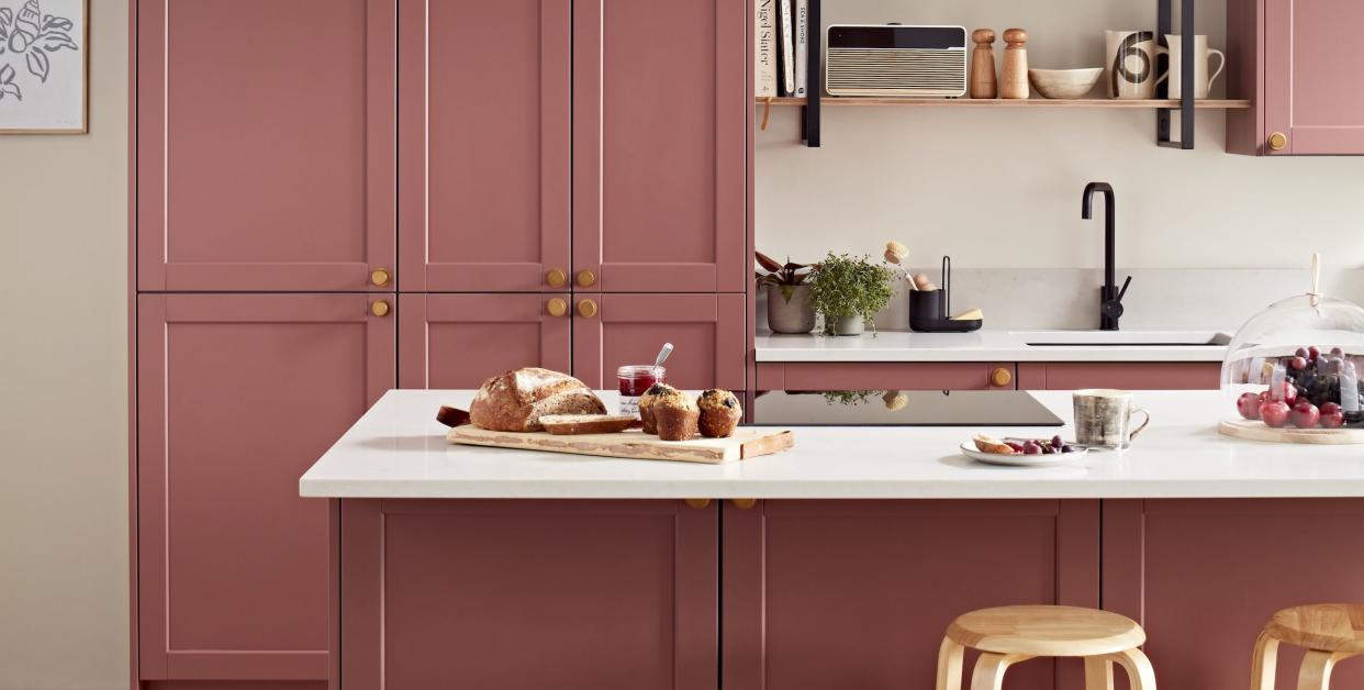 a kitchen with a pink cabinet