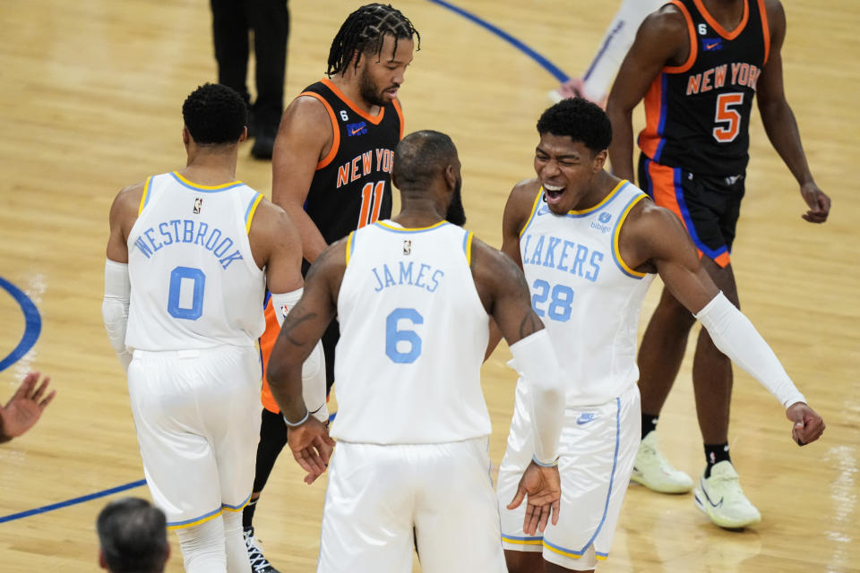 Los Angeles Lakers' Rui Hachimura (28), of Japan, celebrates with LeBron James (6) and Russell Westbrook (0) as New York Knicks' Jalen Brunson walks past them after James scored during the second half of an NBA basketball game Tuesday, Jan. 31, 2023, in New York. The Lakers won 129-123 in overtime. (AP Photo/Frank Franklin II)