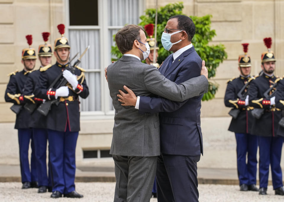 France's President Emmanuel Macron, left, welcomes Niger's President Mohamed Bazoum for a video-summit with leaders of the G5 Sahel at the Elysee Palace, Friday, July 9, 2021. (AP Photo/Michel Euler)