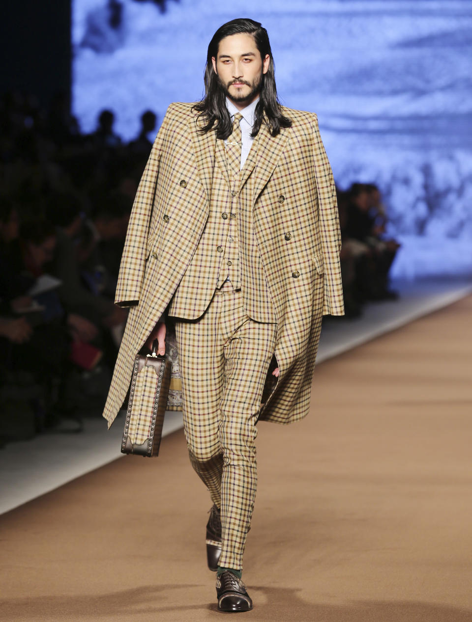 A model wears a creation for Etro men's Fall-Winter 2014 collection, part of the Milan Fashion Week, unveiled in Milan, Italy, Monday, Jan. 13, 2014. (AP Photo/Antonio Calanni)