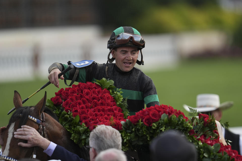 Brian Hernandez Jr. celebrates in the winner's circle after riding Mystik Dan to win the 150th running of the Kentucky Derby horse race at Churchill Downs Saturday, May 4, 2024, in Louisville, Ky. (AP Photo/Abbie Parr)