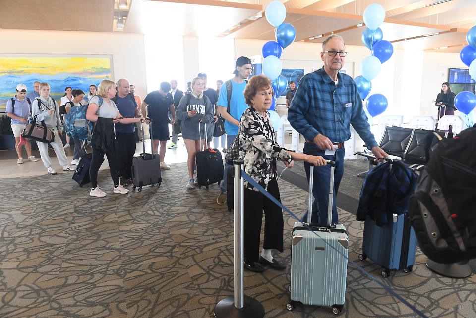 Breeze Airways made its Greenville-Spartanburg International Airport (GSP) based Inaugural Flight at the airport on May 3, 2024. Douglas Heimann and his wife Milicent Kari, right, prepare to board the plane for their flight to Providence.
