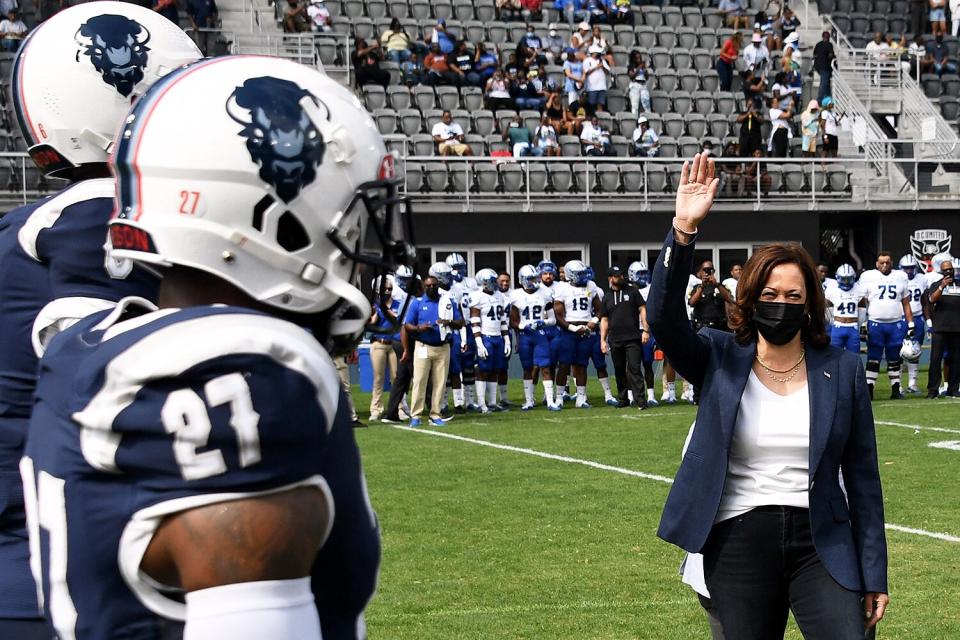 US Vice President Kamala Harris tosses the coin for the football game between Howard University and Hampton University at Audi Field in Washington, DC, on September 18, 2021.