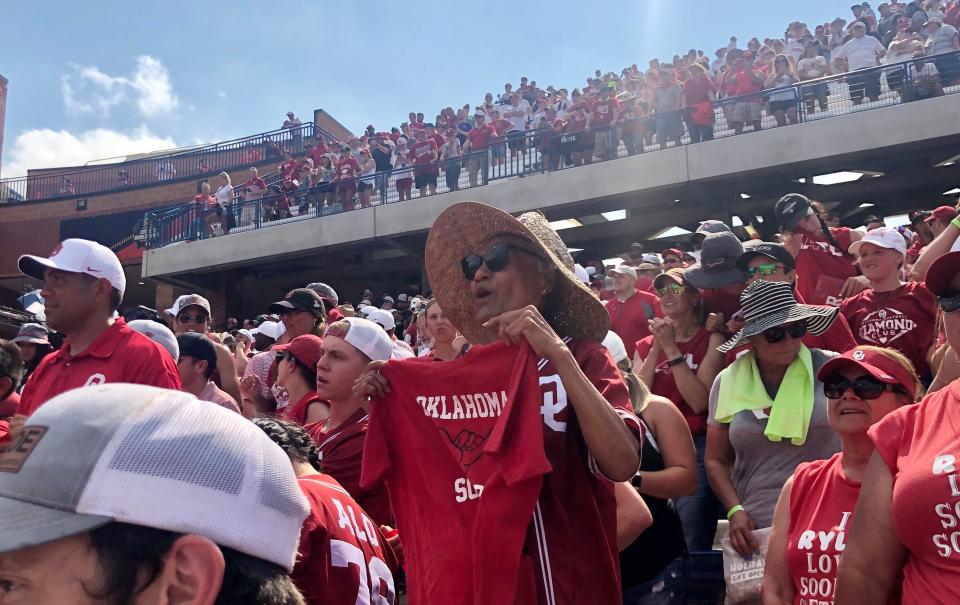 Nita Alo cheers on her granddaughter at the Women's College World Series.