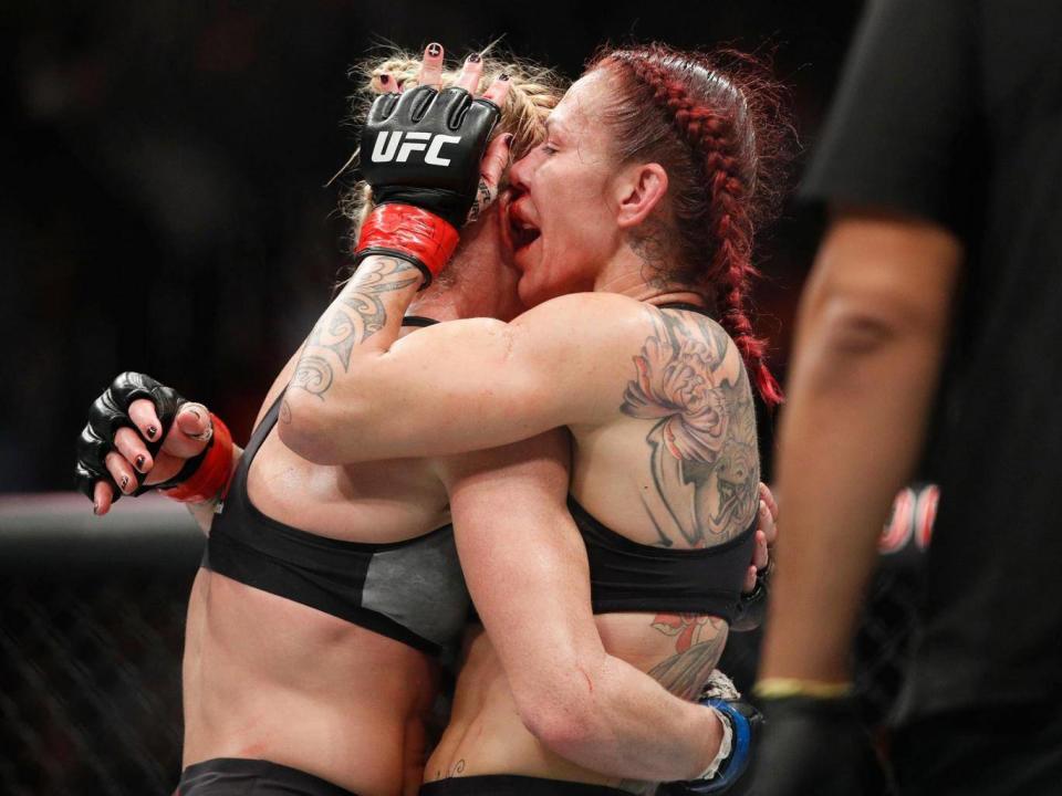 Holm and Cyborg embrace after the final hooter (AP)