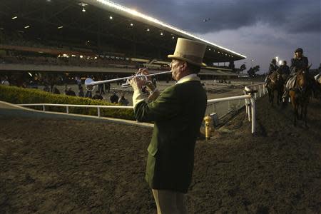 Bugler Jay Cohen calls the horses to the track at Betfair Hollywood Park, which is closing down at the conclusion of tomorrow's race card after operating for 75 years, in Inglewood, California December 21, 2013. REUTERS/Jonathan Alcorn