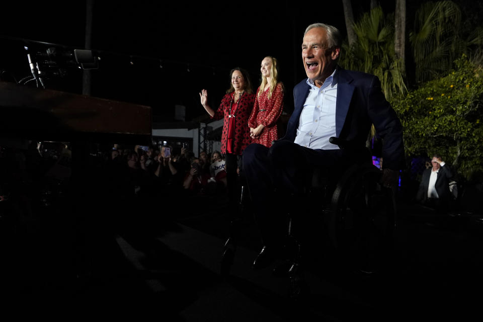 Texas Gov. Greg Abbott arrives to speaks during an election night party Tuesday, Nov. 8, 2022, in McAllen, Texas, with his wife Cecilia Abbott and daughter Audrey. (AP Photo/David J. Phillip)