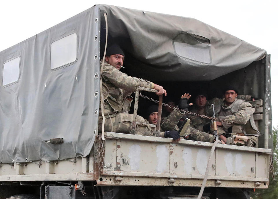 BARDA, AZERBAIJAN - OCTOBER 5, 2020: Azerbaijani servicemen are pictured in a personnel carrier.<span class="copyright">Valery Sharifulin—TASS/Getty Images</span>