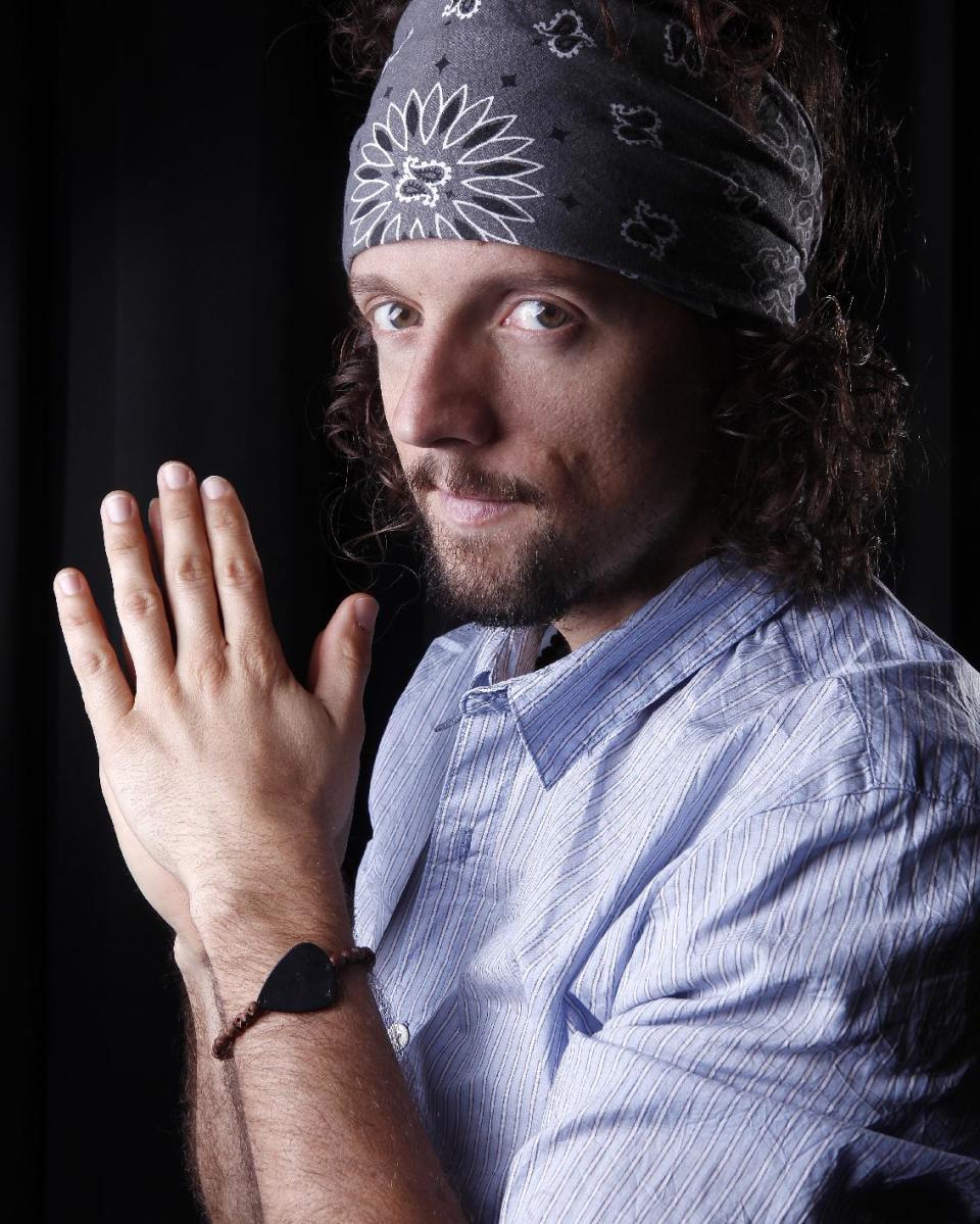 In this March 8, 2012 photo, musician Jason Mraz poses for a portrait in New York. The singer-songwriter, known for feel-good and hippie hits like “I'm Yours” and “The Remedy (I Won't Worry),” released his latest album “Love Is a Four Letter Word,” on Tuesday. (AP Photo/Carlo Allegri)