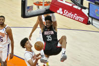 Houston Rockets center Christian Wood (35) dunks over Phoenix Suns forward Cameron Johnson during the first half of an NBA basketball game, Monday, April 12, 2021, in Phoenix. (AP Photo/Matt York)