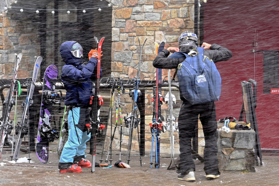 A snow flurry passes as skiers pack up their skis after a day of skiing North Star California Resort on Thursday, Feb. 29, 2024, Truckee, Calif. The most powerful Pacific storm of the season started barreling into the Sierra Nevada on Thursday, packing multiple feet of snow and dangerous winds that forecasters say will create blizzard conditions likely to close major highways and trigger power outages into the weekend. (AP Photo/Andy Barron)