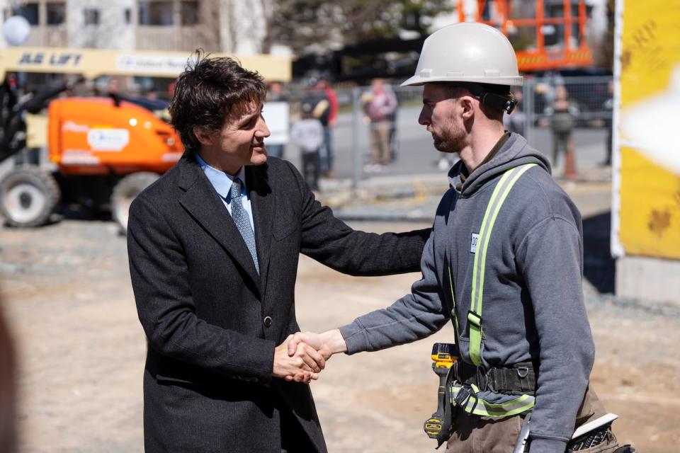 Prime Minister Justin Trudeau greets contractors following a housing announcement in Dartmouth, N.S. on Tuesday. On Wednesday, Trudeau announced a $15-billion top-up to the federal government's apartment construction loan program. (Darren Calabrese/The Canadian Press - image credit)