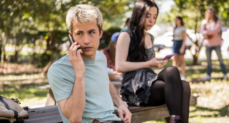 Wes Hicks talking on his phone in the quad