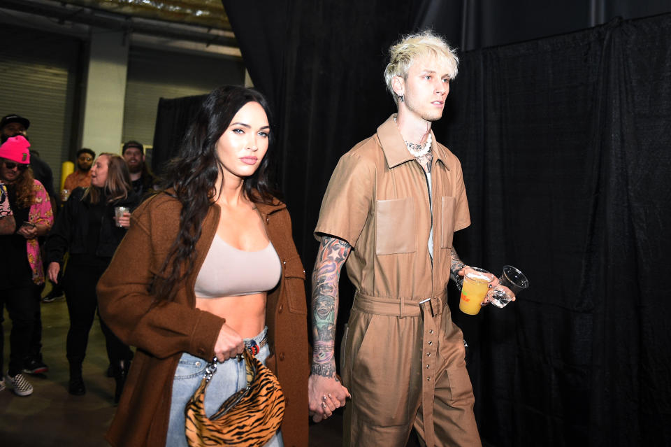 JACKSONVILLE, FLORIDA - APRIL 24: (L-R) Megan Fox and Machine Gun Kelly arrive backstage during the UFC 261 event at VyStar Veterans Memorial Arena on April 24, 2021 in Jacksonville, Florida. (Photo by Chris Unger/Zuffa LLC)