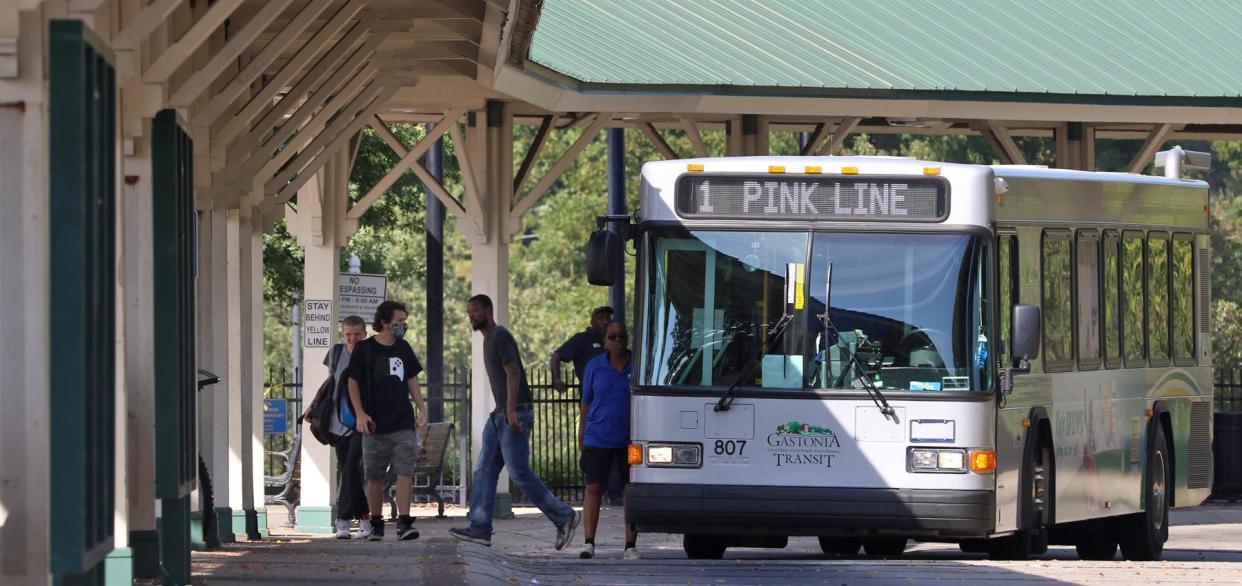 Riders exit the Pink Line Gastonia Transit bus at Bradley Station Thursday afternoon, Oct. 8, 2020.