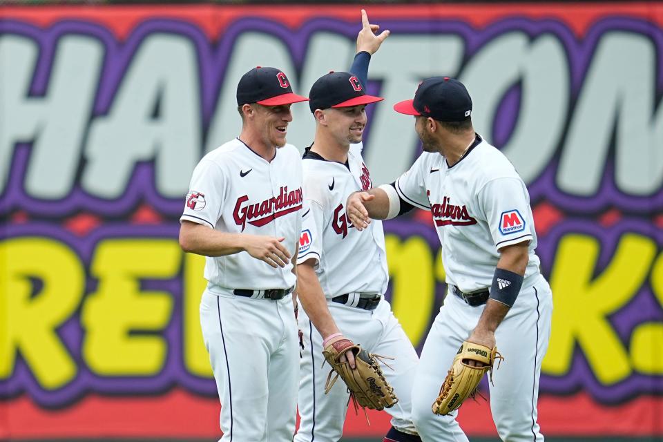 Cleveland Guardians center fielder Myles Straw, left, right fielder Will Brennan, center, and right fielder Ramón Laureano, right, celebrate after the Guardians defeated the Minnesota Twins Sept. 6, 2023, in Cleveland.