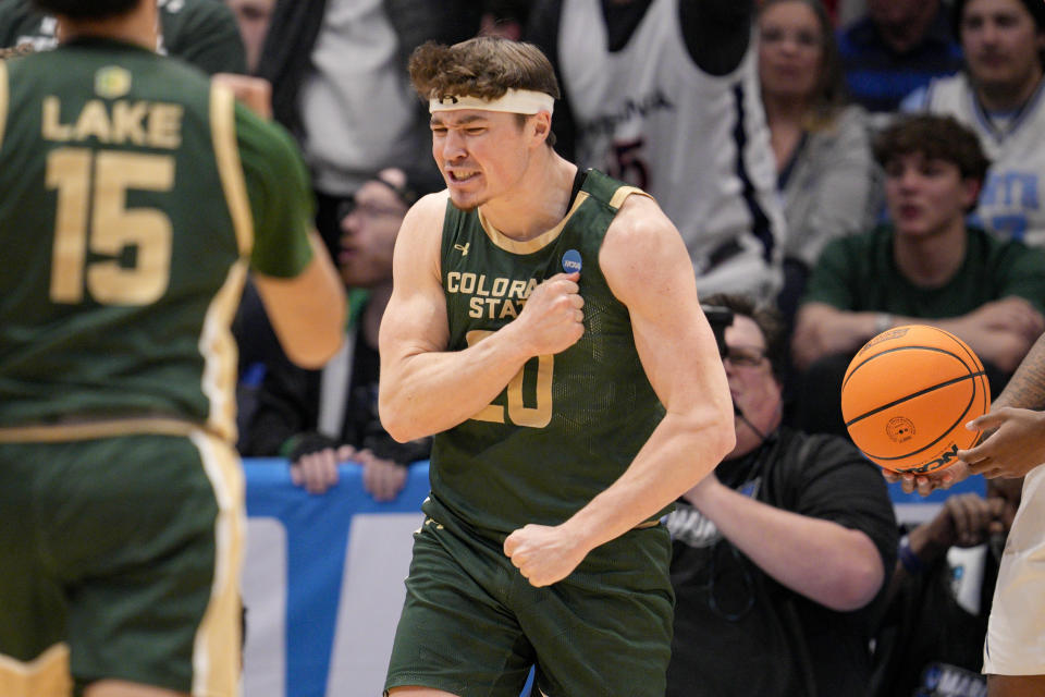 Colorado State's Joe Palmer, center, reacts after winning a jump ball during the first half of a First Four college basketball game against Virginia in the NCAA Tournament in Dayton, Ohio, Tuesday, March 19, 2024. (AP Photo/Jeff Dean)