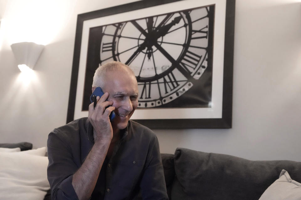 Winner of the 2023 Nobel Prize in Chemistry Massachusetts Institute of Technology scientist Moungi Bawendi speaks on a phone at his home, in Cambridge, Mass, Wednesday, Oct. 4, 2023. Bawendi, of MIT; Louis Brus, of Columbia University; and Alexei Ekimov, of Nanocrystals Technology Inc., were honored for their work with the particles that "have unique properties and now spread their light from television screens and LED lamps," according to the Royal Swedish Academy of Sciences, which announced the award in Stockholm. (AP Photo/Steven Senne)