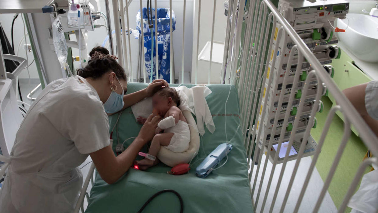 A pediatric doctor tends to a baby hospitalised at the pediatric emergency unit at the Robert Debre hospital in Paris on October 28, 2022. (Photo by ALAIN JOCARD / AFP) / “The erroneous mention[s] appearing in the metadata of this photo by ALAIN JOCARD has been modified in AFP systems in the following manner: [pediatric doctor] instead of [nurses]. Please immediately remove the erroneous mention[s] from all your online services and delete it (them) from your servers. If you have been authorized by AFP to distribute it (them) to third parties, please ensure that the same actions are carried out by them. Failure to promptly comply with these instructions will entail liability on your part for any continued or post notification usage. Therefore we thank you very much for all your attention and prompt action. We are sorry for the inconvenience this notification may cause and remain at your disposal for any further information you may require.”