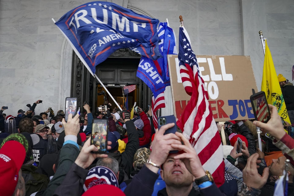 FILE - In this Jan. 6, 2021, file photo, Trump supporters gather outside the Capitol in Washington. Online supporters of Trump are scattering to smaller social media platforms, fleeing what they say is unfair treatment by Facebook, Twitter and other big tech firms looking to squelch misinformation and threats of violence. (AP Photo/John Minchillo, File)