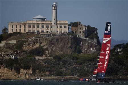 Oracle Team USA crosses the finish line ahead of Emirates Team New Zealand to win Race 17 of the 34th America's Cup yacht sailing race in San Francisco